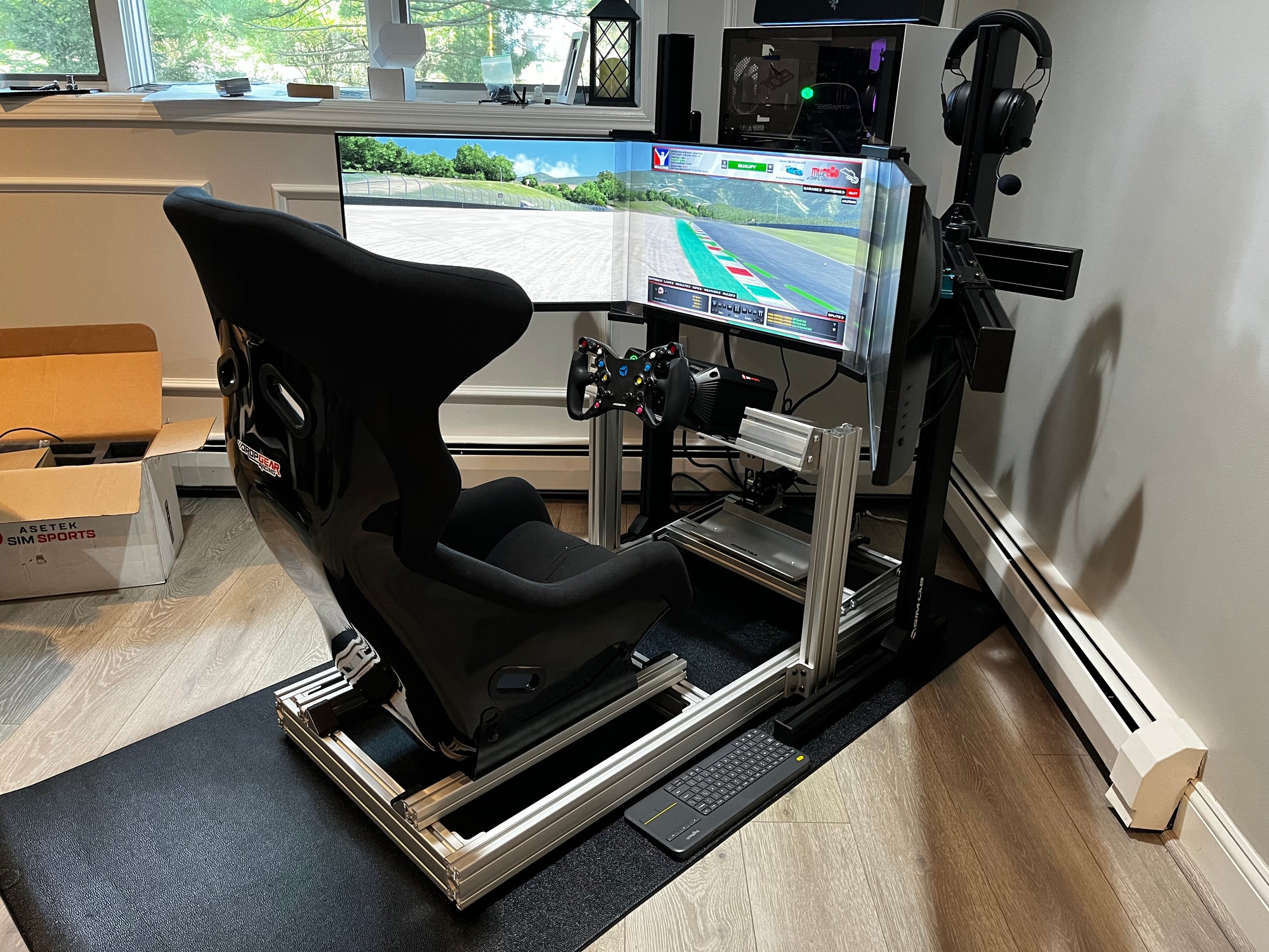 A high-quality racing simulator setup featuring a sturdy cockpit with a mounted racing wheel, pedals, and a comfortable racing seat, providing an immersive sim racing experience.